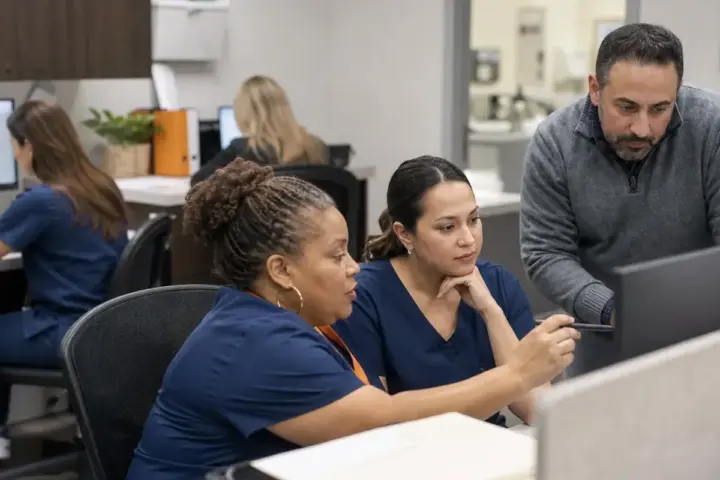 Physicians and practice administrator reviewing medical billing operations