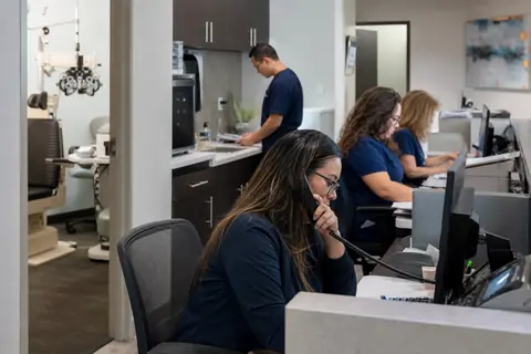 Ophthalmology practice staff managing patient and billing workflows